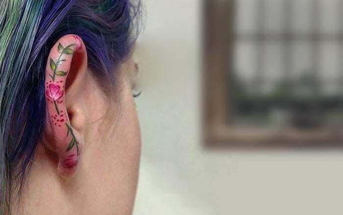 Black lines tattoo on the left ear - Tattoogrid.net