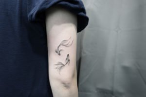 Pisces Black and Gray Arm Tattoo