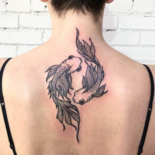 Pisces tattoo on the upper back  Tattoogridnet