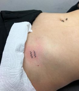 Aquarius Symbol Hip Tattoo