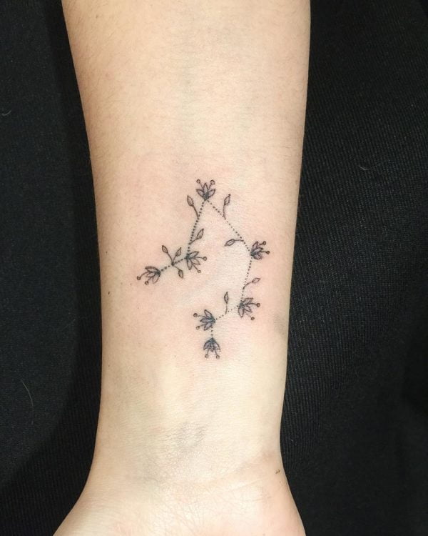 Libra symbol and tiny heart tattooed on the wrist