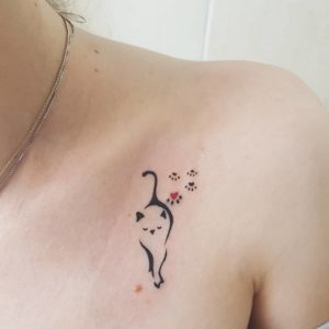 Cat Outline and Paw Print Collarbone Tattoo