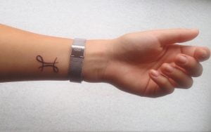 Mini Gemini Symbol Line Art Wrist Tattoo