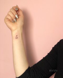 Airplane and Heart Wrist Tattoo