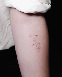 Abstract Two Face Forearm Tattoo