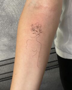 Flower And Female Body Forearm Tattoo