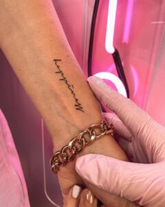 Happiness Script Wrist Tattoo