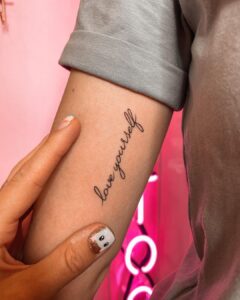 Love Yourself Script Bicep Tattoo