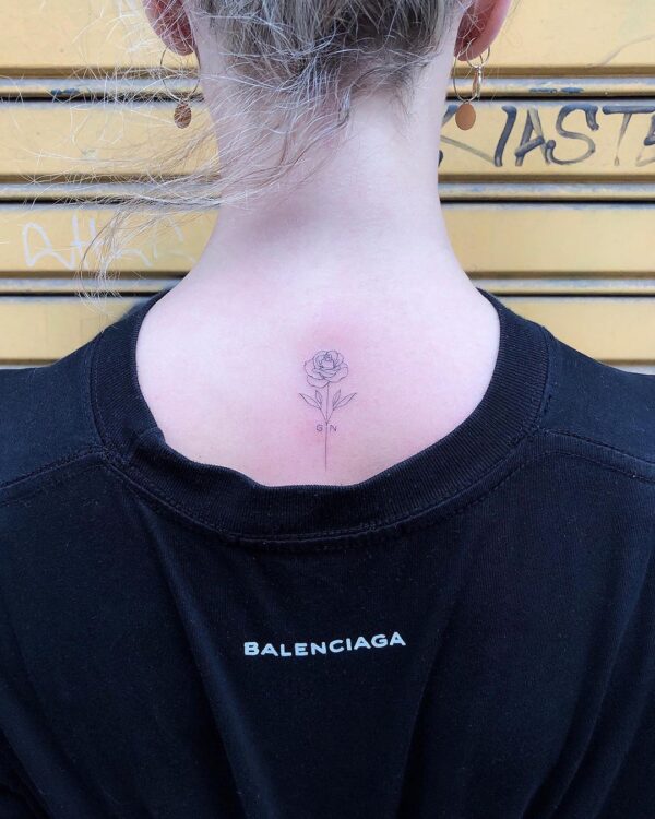 Fine line Virgin Mary tattoo on the back of the neck