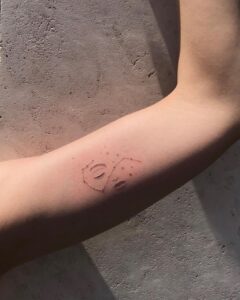 Scorpio Constellation And Face Upper Arm Tattoo