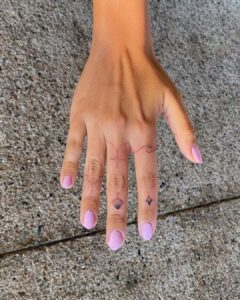 Shell And Star Finger Tattoo