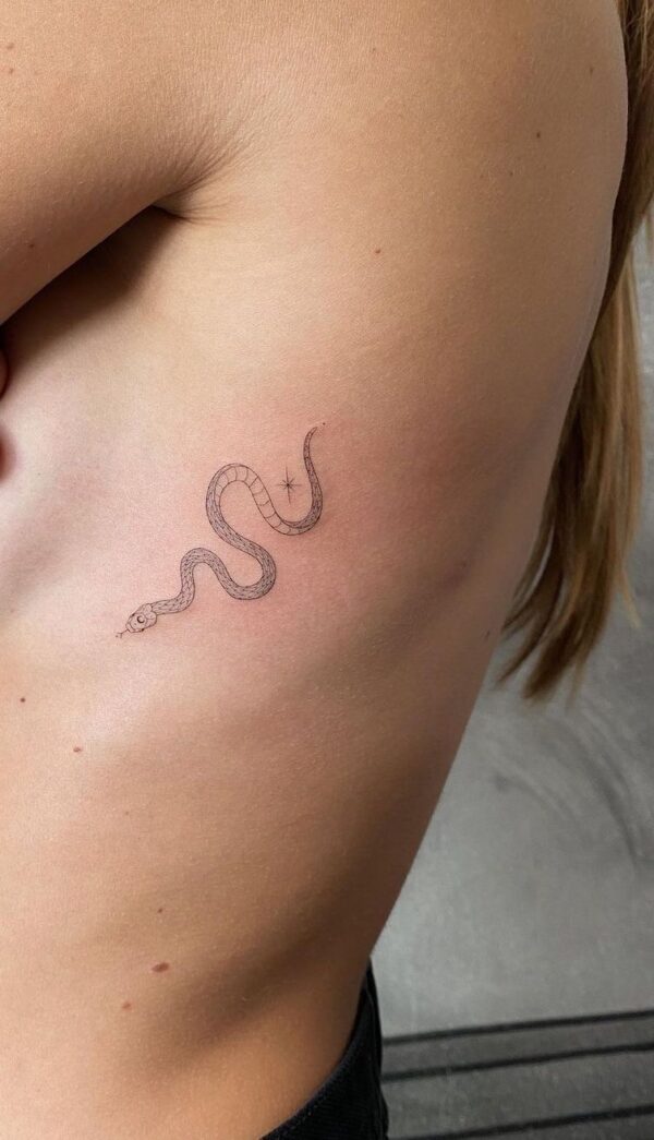 Fine line snake tattoo on hip
