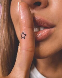 Star Outline Finger Tattoo