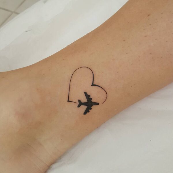 Airplane Flying in a Heart Ankle Tattoo