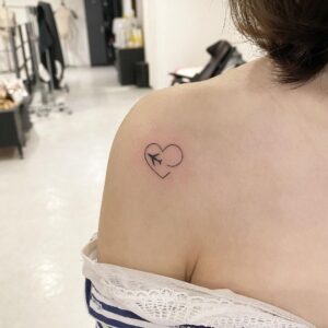 Airplane with Heart Trail Collarbone Tattoo