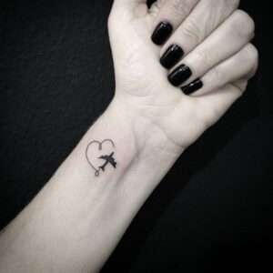 Airplane and Heart Wrist Tattoo
