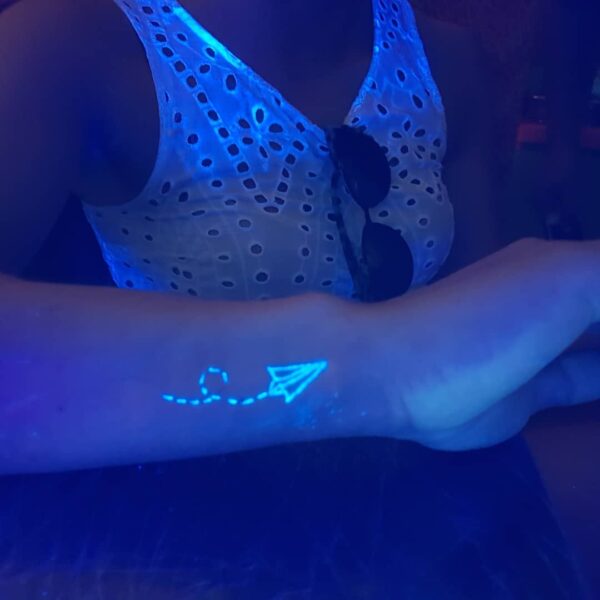 Blacklight Airplane Wrist Tattoo