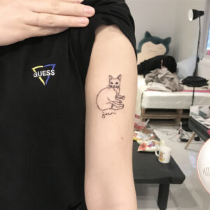 Illustrative Cat Upper Arm Tattoo
