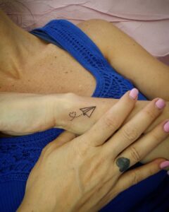 Paper Airplane and Heart Wrist Tattoo