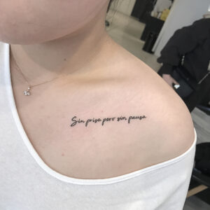 Slowly But Surely Lettering Collarbone Tattoo