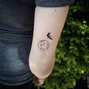 Woman Circling the Globe Back of Arm Tattoo