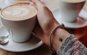 small paw print tattoo on wrist