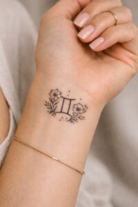Gemini Symbol with Floral Inner Wrist Tattoo